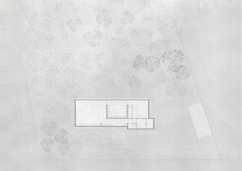 Floor plan drawing of a linear rectangular building with surrounding trees and curved topographic lines