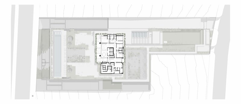 Roof plan showing the building footprint with adjacent landscaped courtyards and property boundary