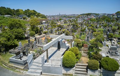 This architectural image showcases a cemetery with a modern, minimalist memorial structure. The memo