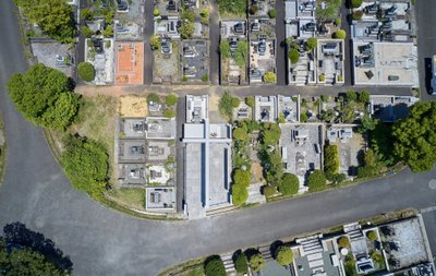 This aerial photograph showcases a meticulously planned cemetery with a geometric layout. The design