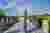 This architectural image showcases a modern memorial site within a cemetery. The design features a c