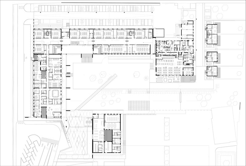 Floor plan drawing showing the L-shaped building layout with central courtyard and adjacent site structures