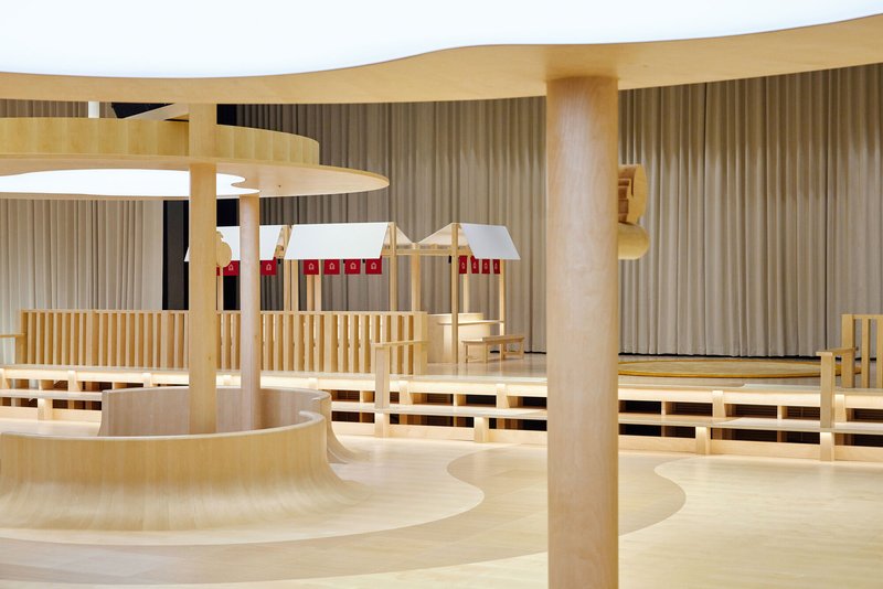 Seating area with horizontal timber slat screens and white pendant lamps with red accent bands