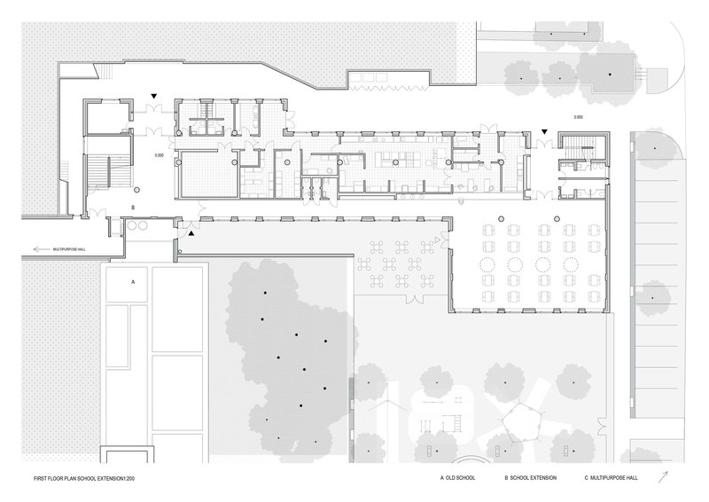 First floor plan drawing showing classrooms wrapping a landscaped courtyard with multiple circulation zones