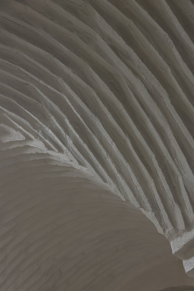 Interior view of layered ribbed ceiling vaulting in white textured material