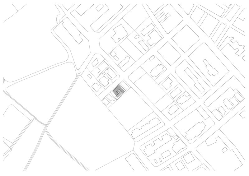 Site plan drawing showing rectangular footprint surrounded by streets and neighboring buildings