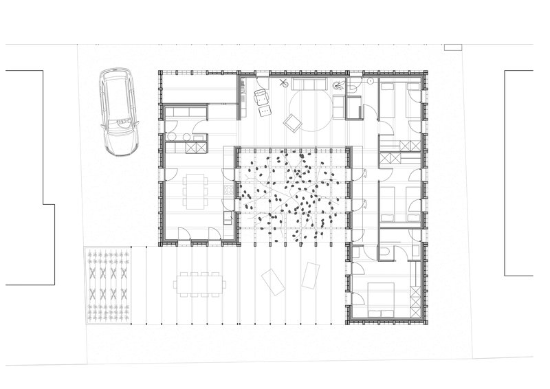 Floor plan drawing showing rooms arranged around a central courtyard with a tree and pebble ground cover