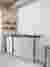 This architectural image showcases a minimalist kitchen corner with a focus on functionality and cle