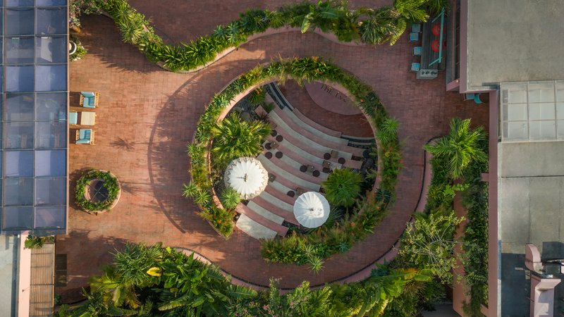 Overhead view of the concentric circular terrace with two white parasols at its center