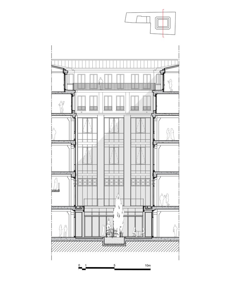 Section drawing showing a full-height glazed atrium with balconies and figures for scale