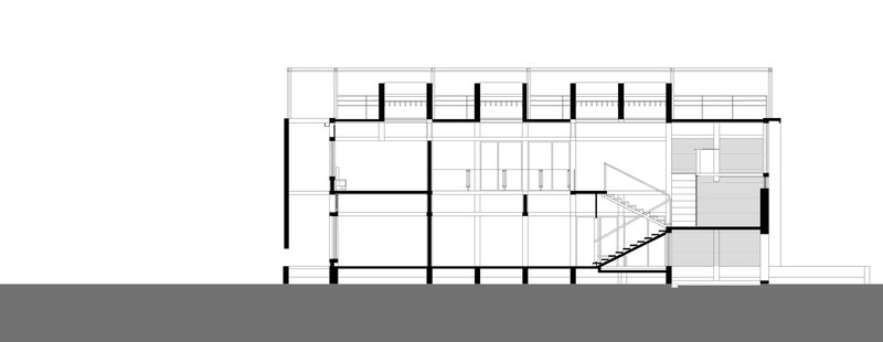 Section drawing revealing split-level interior spaces with staircase connecting multiple floor plates