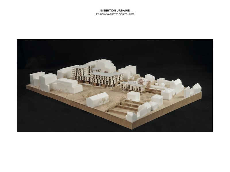 Site model showing buildings with chequered facades surrounded by white context volumes and landscaping