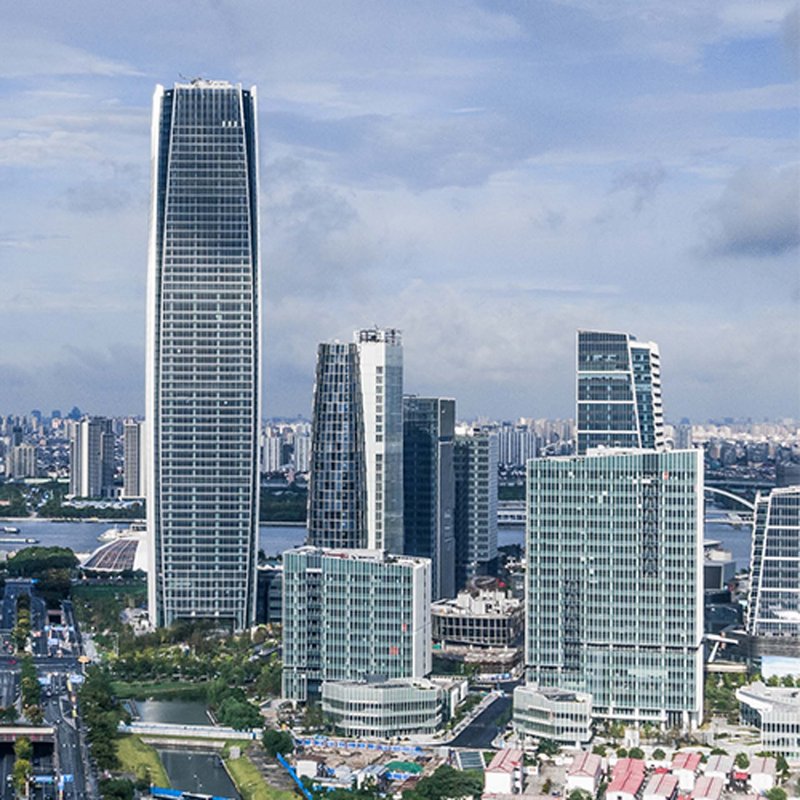 Skyline view of high-rise office towers with curtain wall facades and a distant river