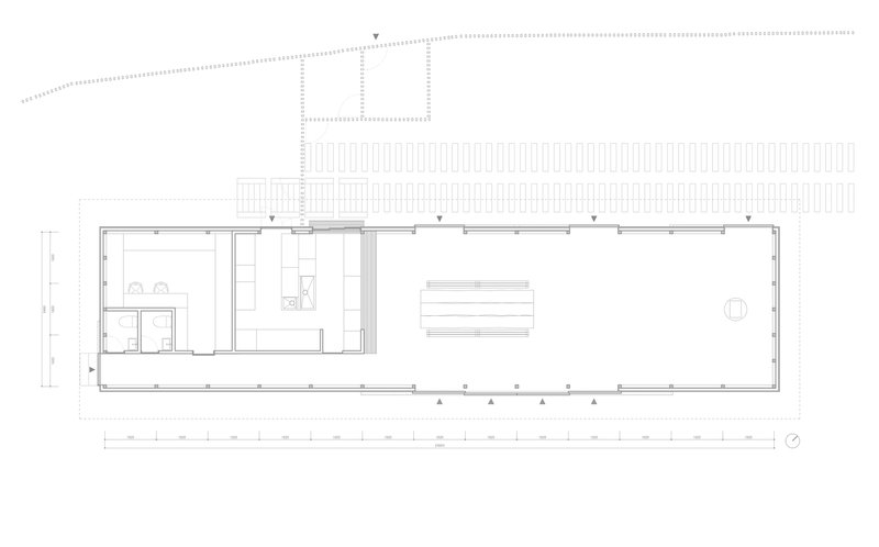 Floor plan drawing showing a linear volume with covered deck, service spaces, and open interior