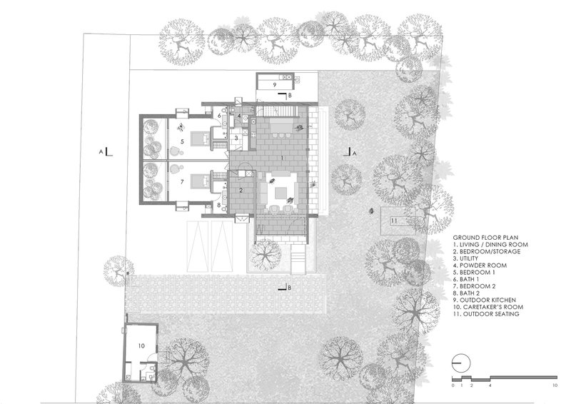Ground floor plan drawing depicting living spaces, bedrooms, and outdoor kitchen surrounded by landscape