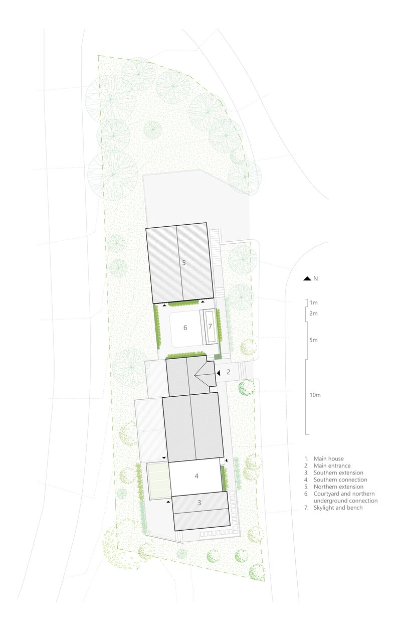 Site plan drawing showing three volumes connected by courtyards and surrounded by landscaping