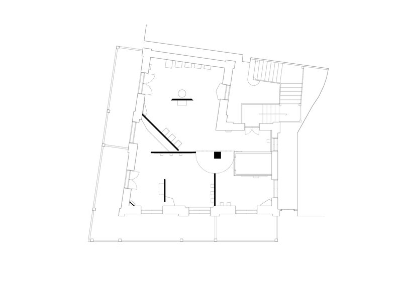 Floor plan drawing showing a central staircase connecting irregular perimeter rooms with an outdoor terrace