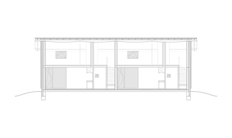 Section drawing showing two adjoining two-story units with central staircase and upper sleeping areas