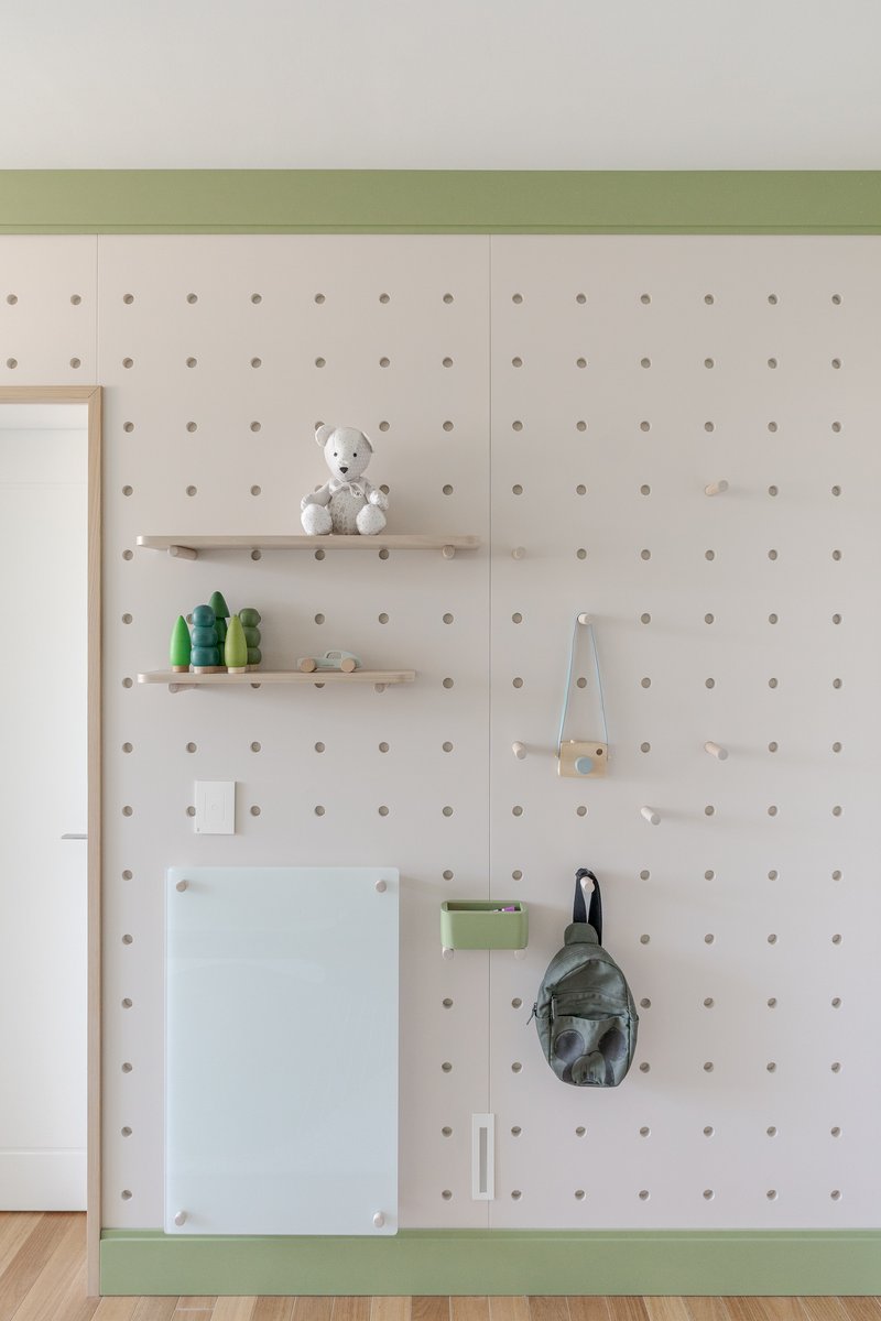 Pegboard wall in white with timber trim, floating shelves, and green baseband detail