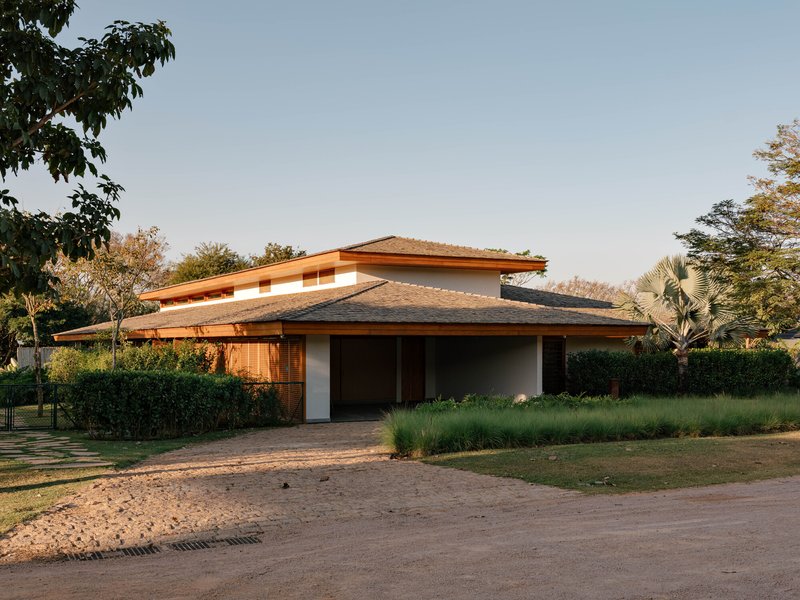 Street view of the layered timber roof with wide eaves at golden hour