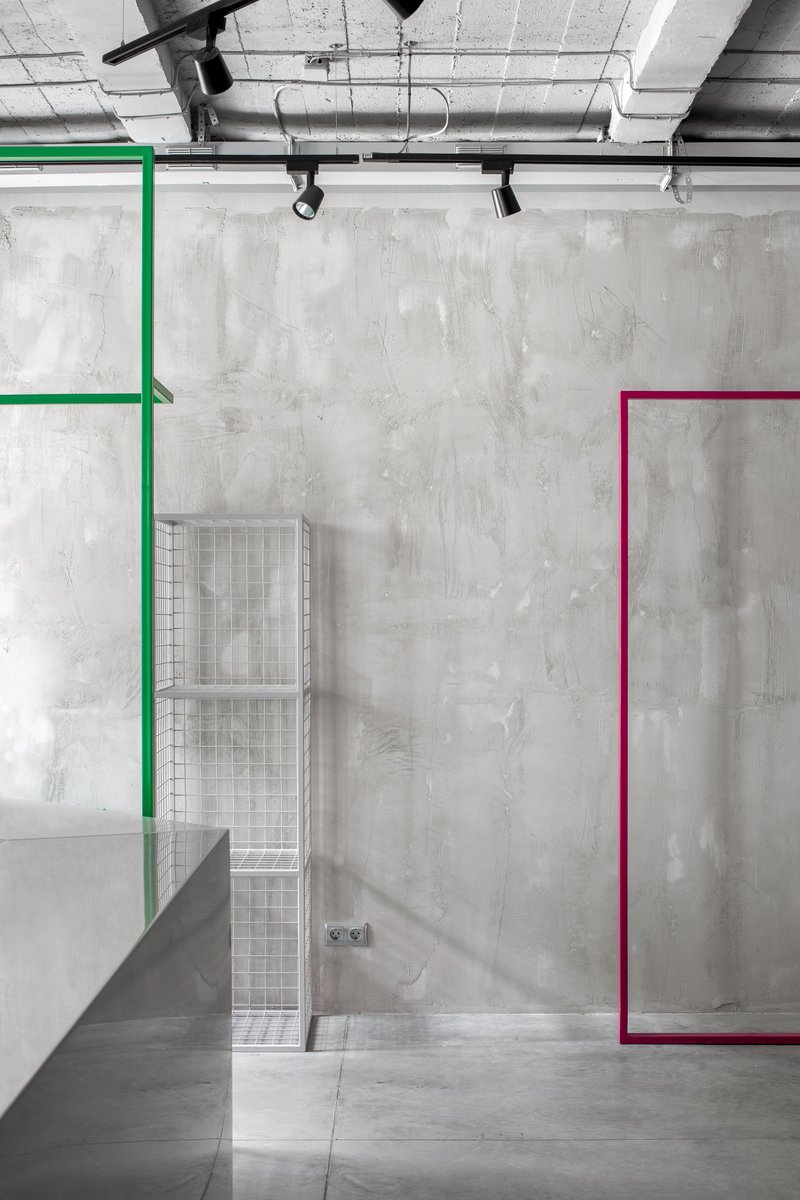 Flexible exhibition system with colored frames defining adaptable retail zones.