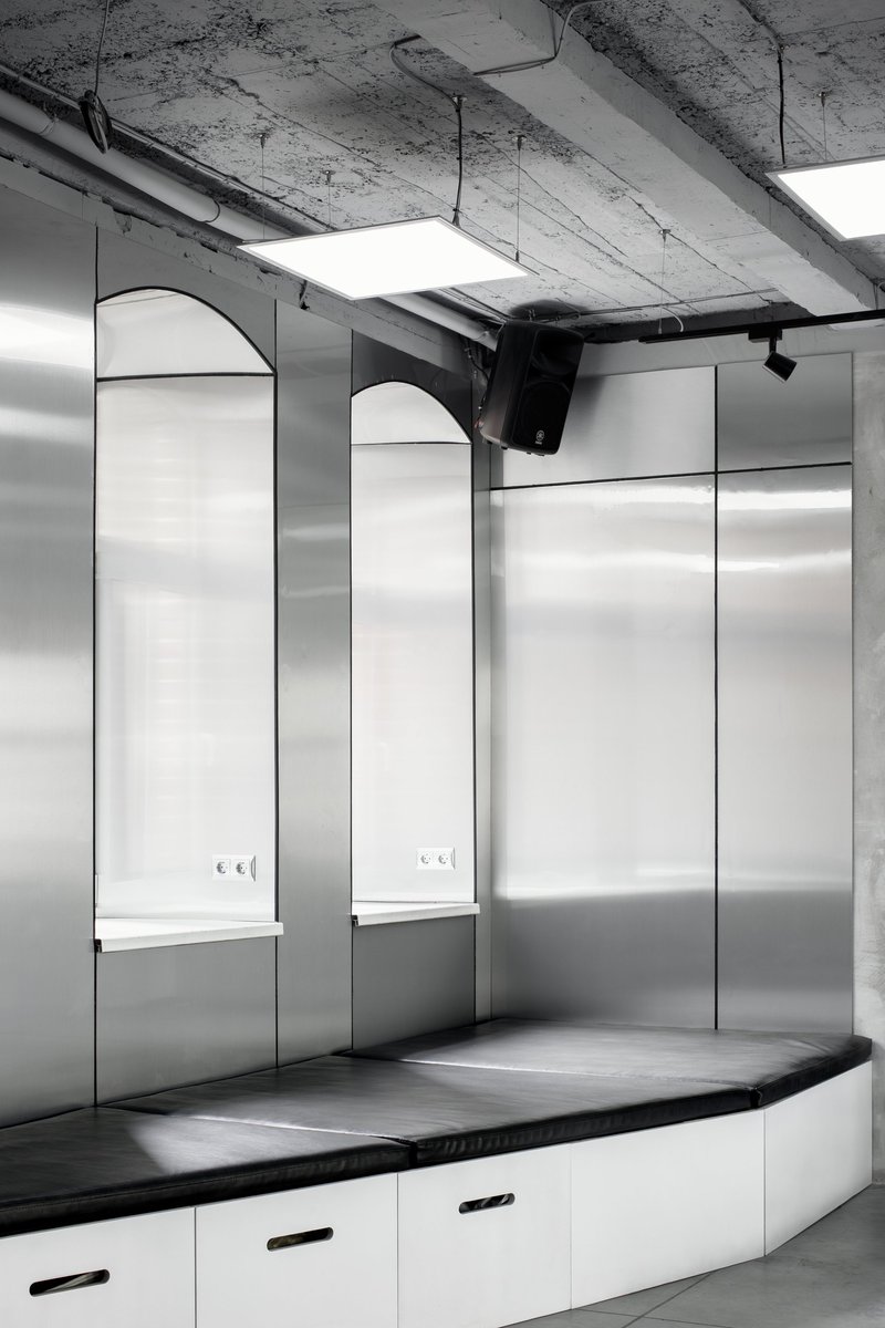 Industrial ceiling with track lighting enabling adjustable exhibition illumination.