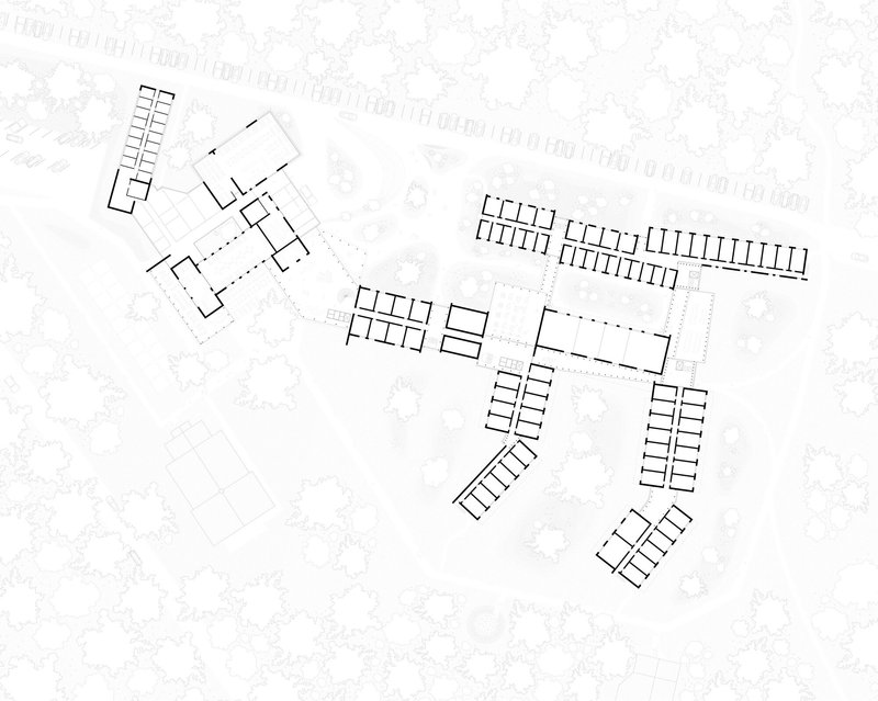 Site plan drawing showing multiple linear building blocks arranged around a central courtyard with surrounding trees