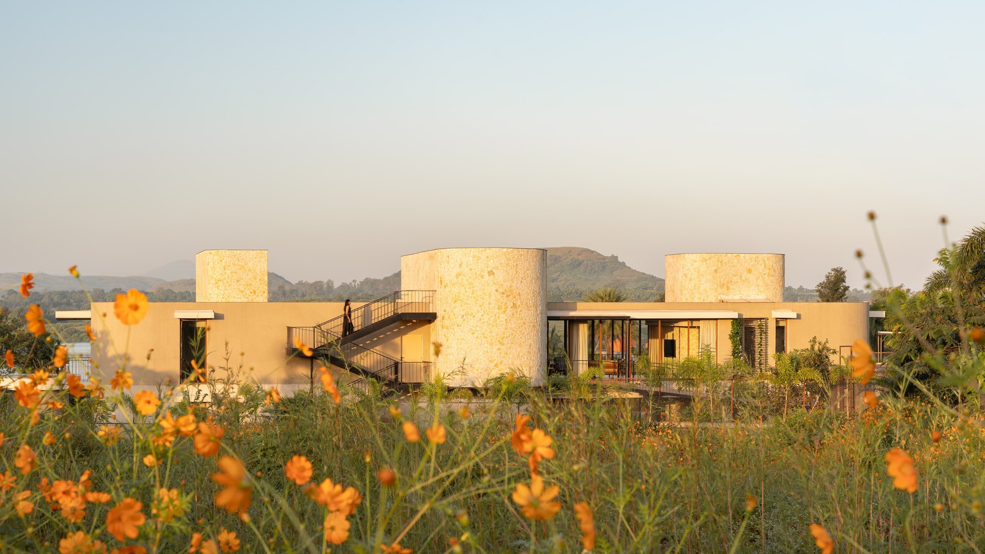 Atelier Landschaft Wraps a Lakeside Micro-Resort in Stone Cylinders at the Edge of an Indian Dam
