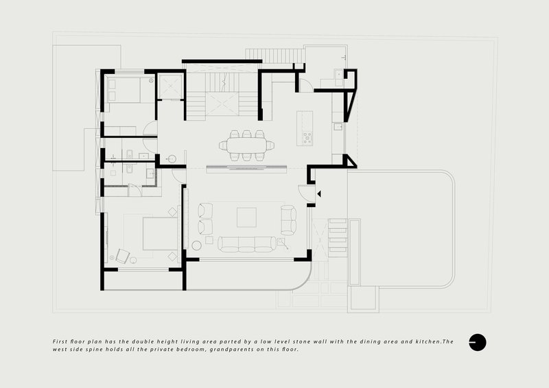 First floor plan with double-height living area divided by a low stone wall separating dining and kitchen