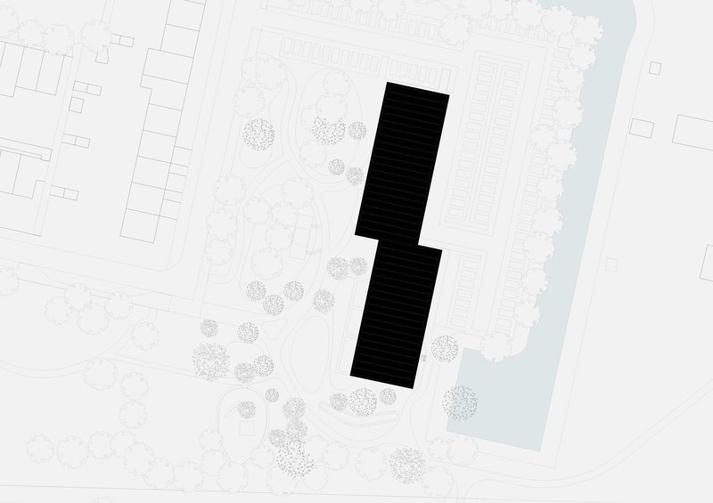 Site plan showing two tower footprints in a landscaped park beside a waterway