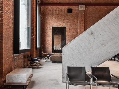 Objekt Architecten Pours a Concrete Disc Through an Aalst Weaving Mill Turned Showroom