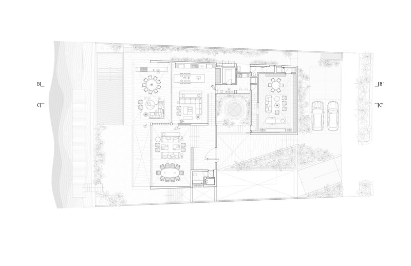 First floor plan drawing showing living and dining areas with circular courtyard and flanking landscape zones