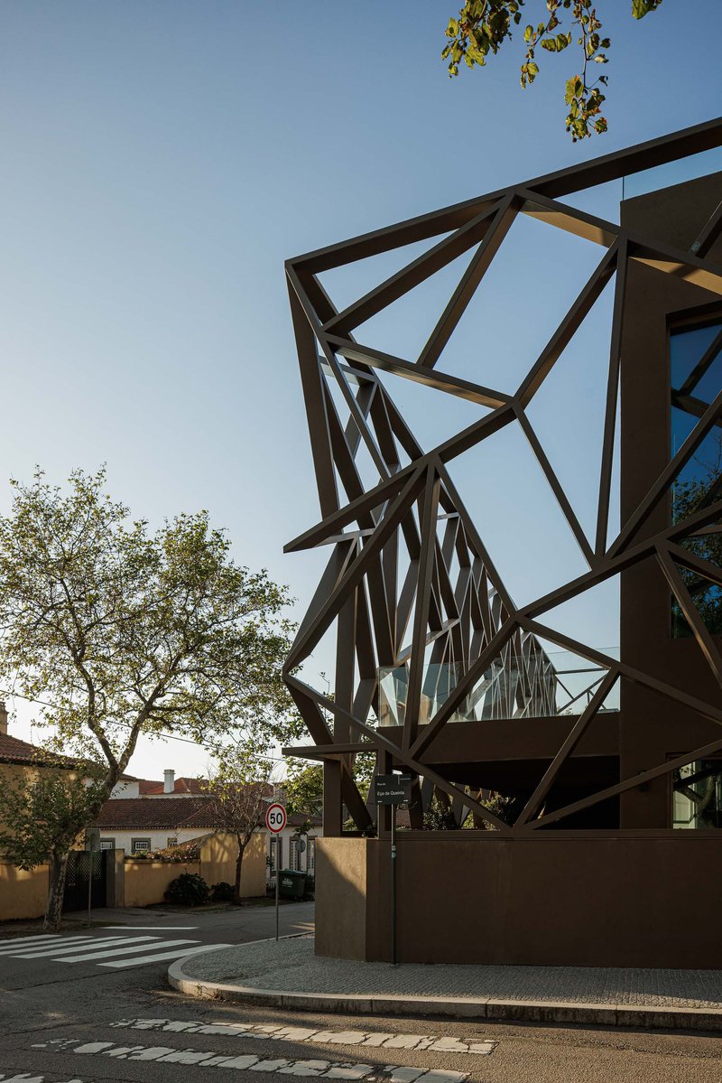 Angular steel structural frame supporting a canopy at the street entrance