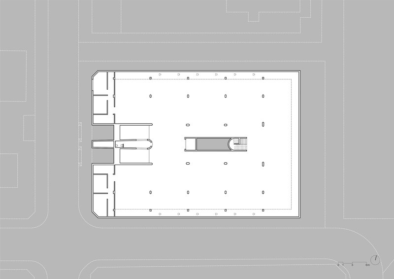 Ground floor plan drawing showing open parking layout with central stair and service core