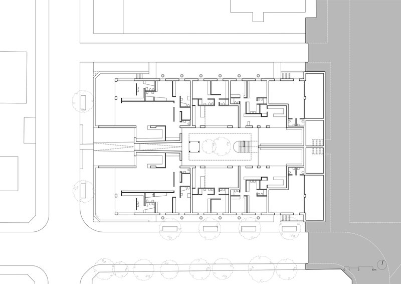 Ground floor plan drawing showing residential units arranged around a central courtyard with trees