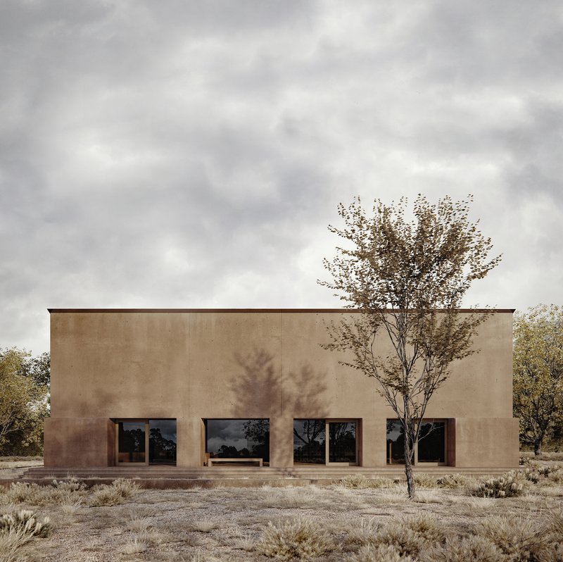 Flat facade with large square windows and central tree casting shadows on earthen wall