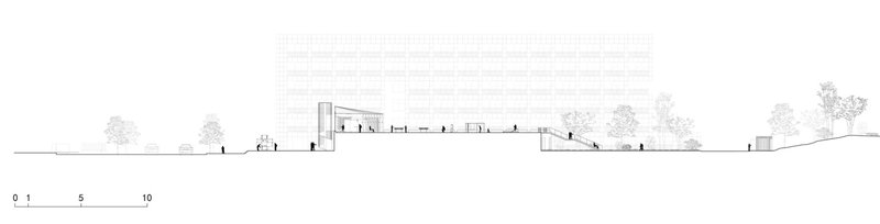 Section drawing showing the building profile with sloped terrain and surrounding trees in elevation