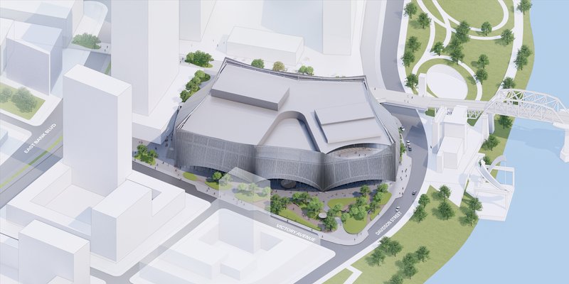 Aerial view of rendered site model depicting the folded roof volumes surrounded by landscaping and streets