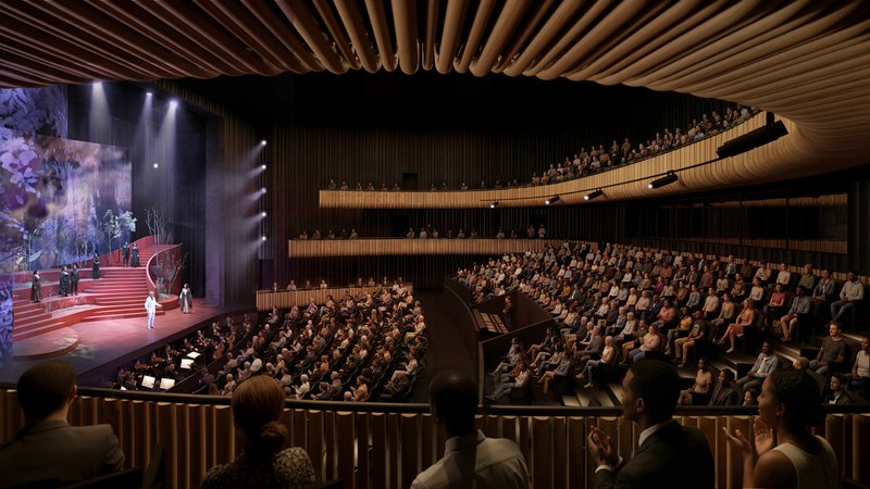 Auditorium interior showing cantilevered balconies wrapped in timber slats and an undulating ceiling above the audience