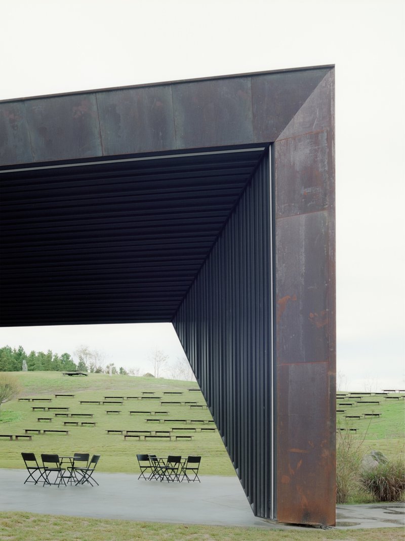 Detail of the weathered steel frame meeting the ribbed soffit above the concrete terrace