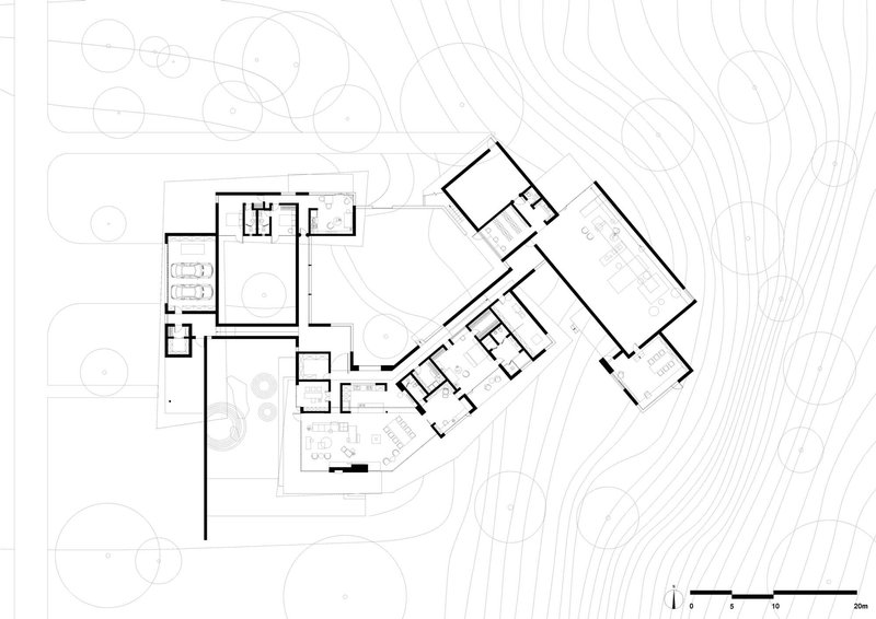Floor plan drawing showing angled residential volumes with a courtyard and topographic contours