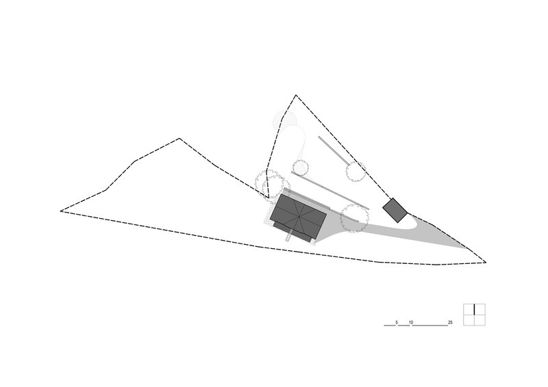Site plan drawing showing two rectangular volumes and a circular element on a triangular sloped lot