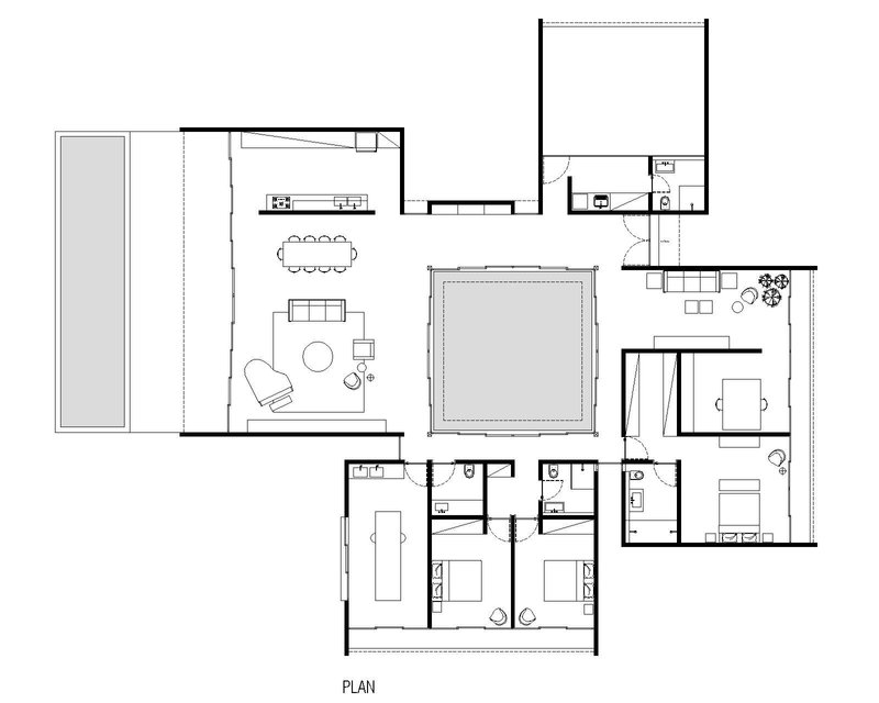 Floor plan drawing showing living spaces wrapping around a central courtyard pool with bedrooms clustered at one end