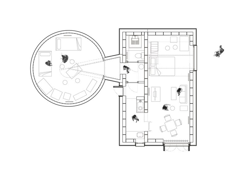 Floor plan drawing showing a circular room adjoining a rectangular volume with furniture layout