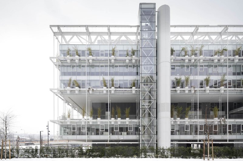 Elevation showing the white structural frame with planted terraces on each level during winter