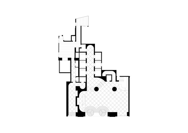 Floor plan drawing showing an irregular layout with a large central hall and flanking service rooms