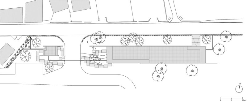 Roof plan drawing illustrating the structure's elongated form with surrounding vegetation and site context