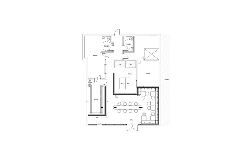 Floor plan drawing showing the layout of restrooms, kitchen, storage, and seating areas