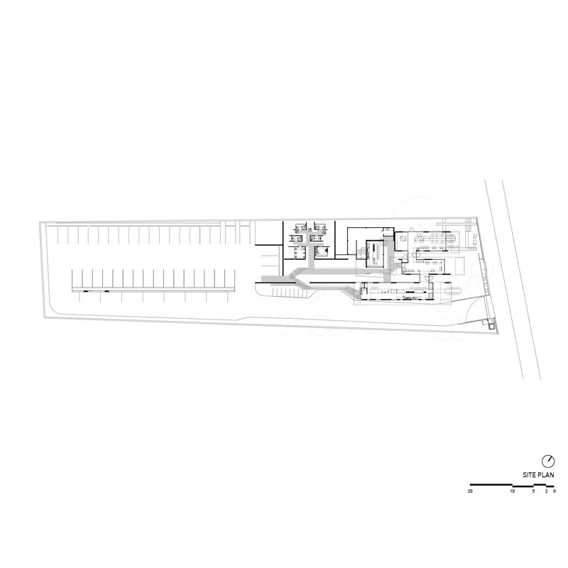 Site plan drawing showing a linear parking area and rectangular building footprint on an angled lot