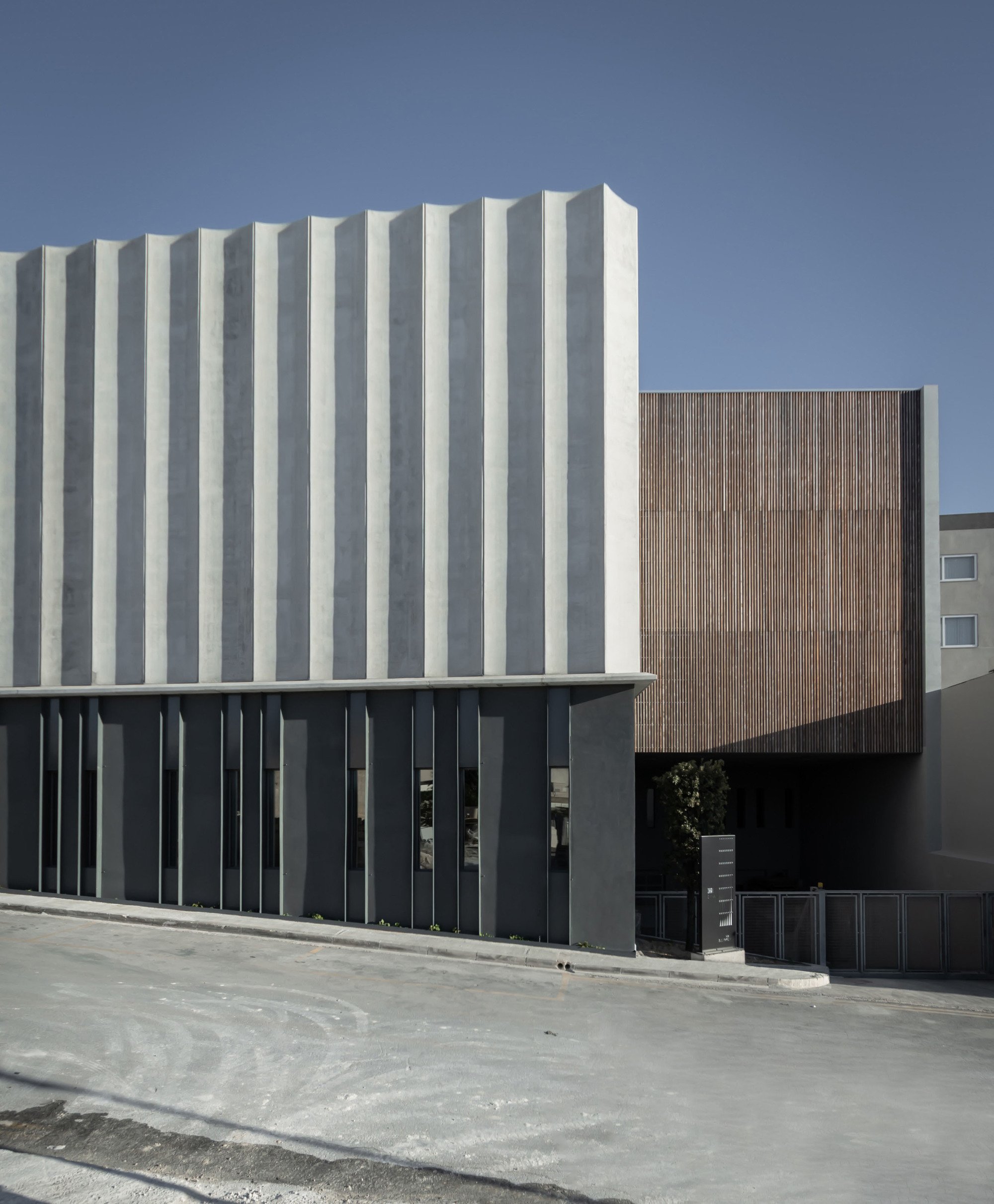 Chris Briffa Architects Wraps a Maltese Furniture Factory in a Curtain of Precast Concrete